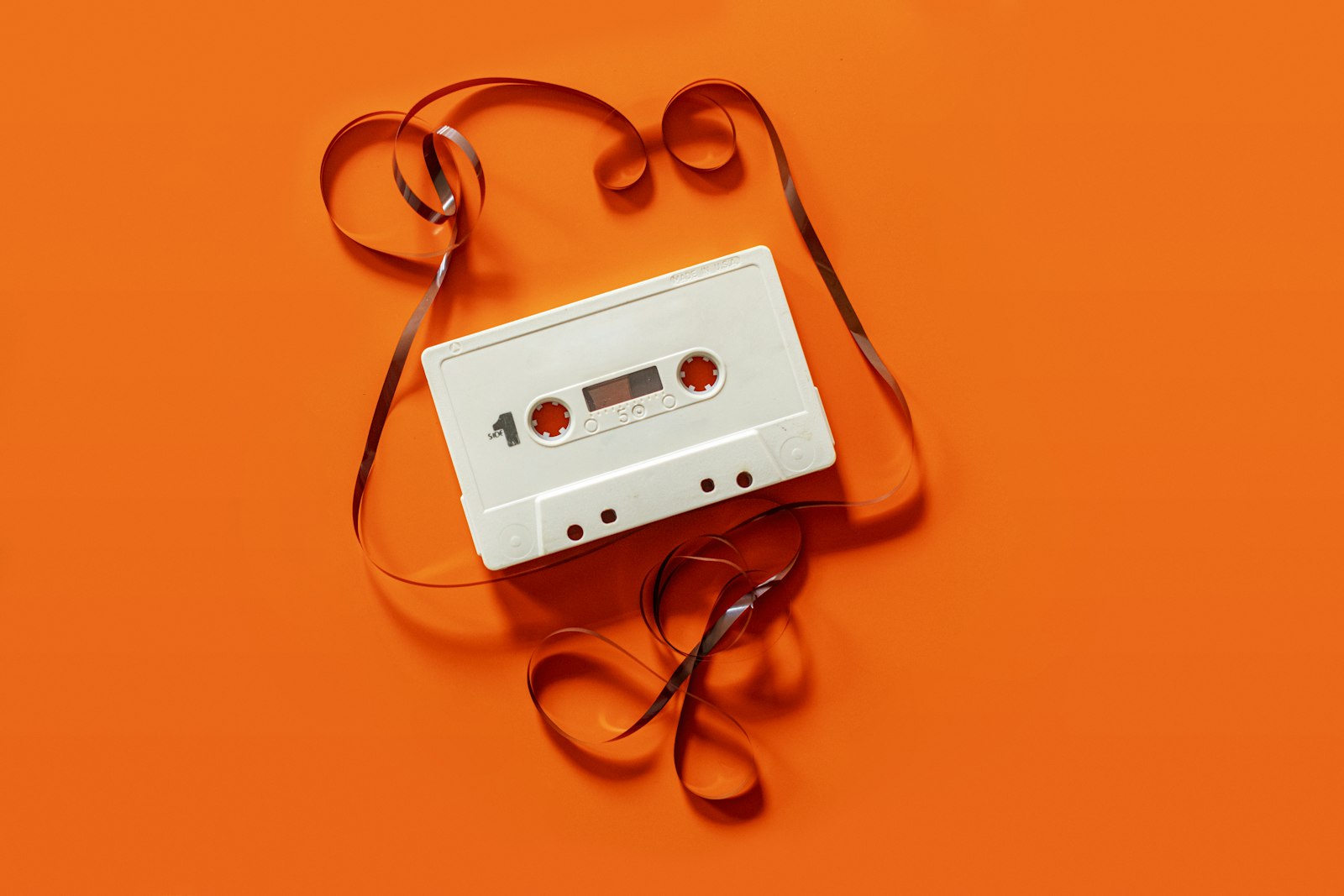 Cassette tape unspooled on orange