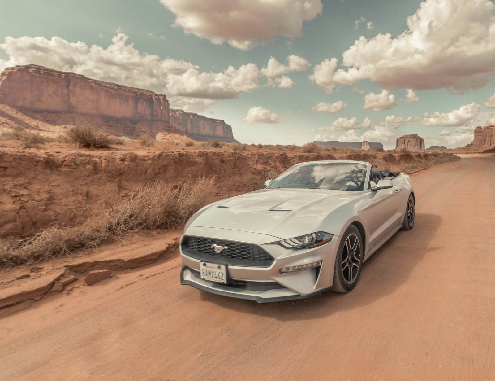 White convertible on a desert dirt road