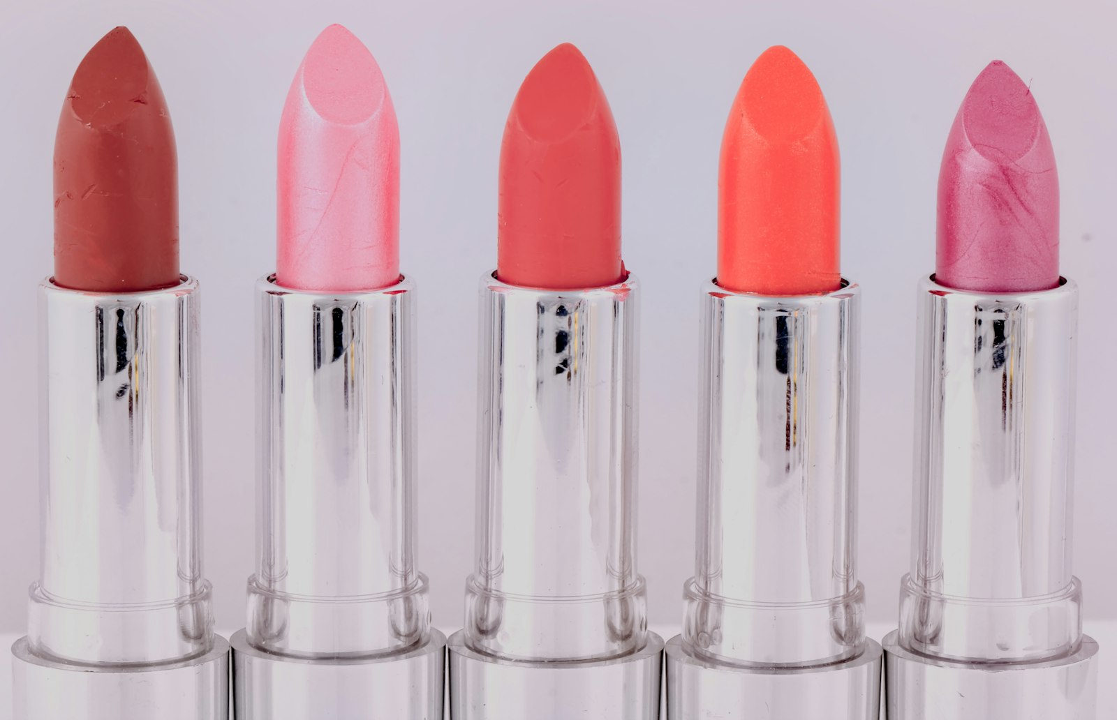 Row of pink and coral lipsticks
