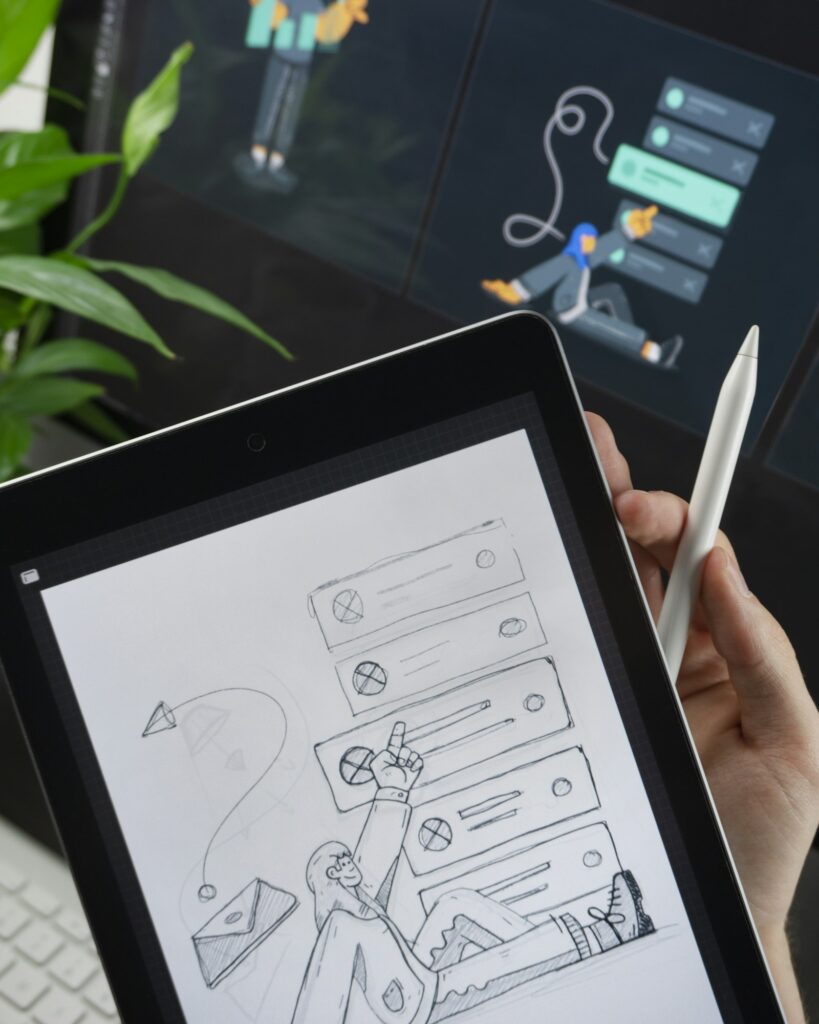 Hand holding tablet with wireframe sketch and stylus