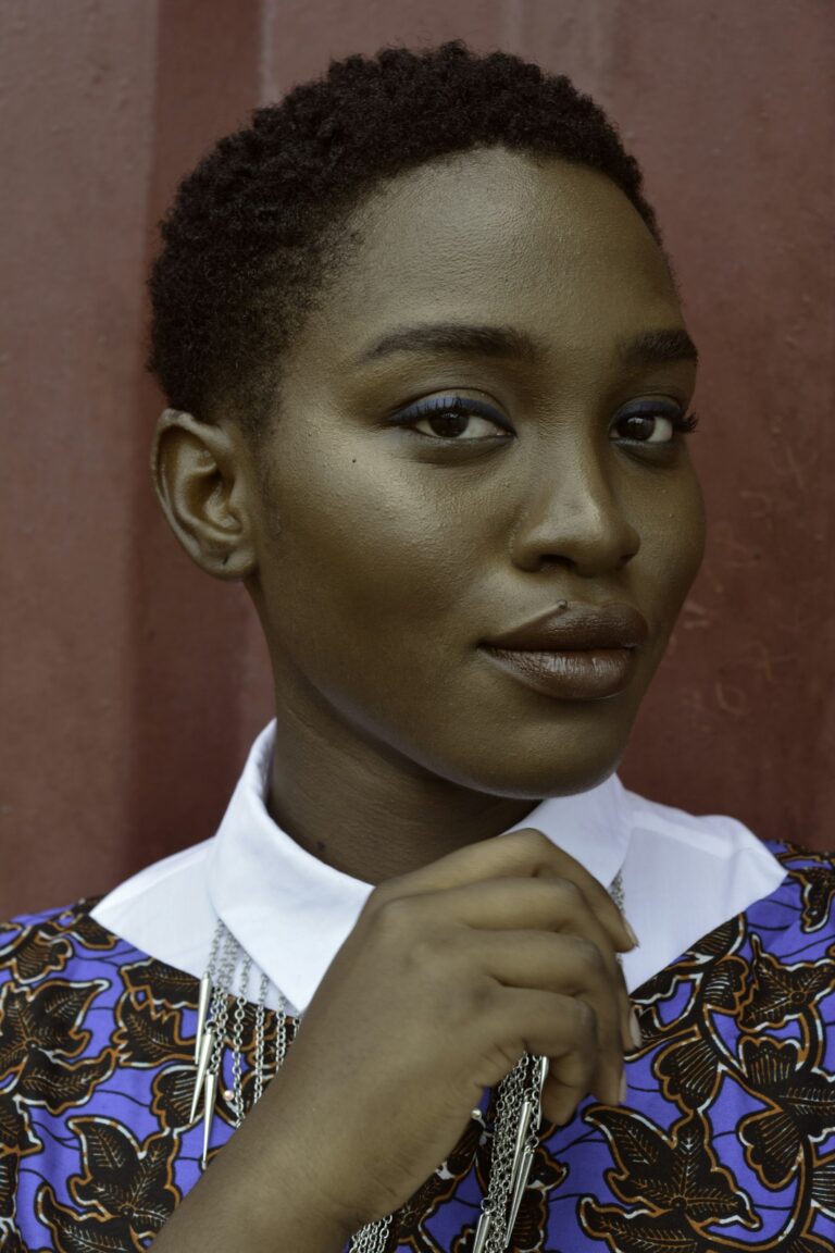 Woman with cropped hair in printed collared shirt